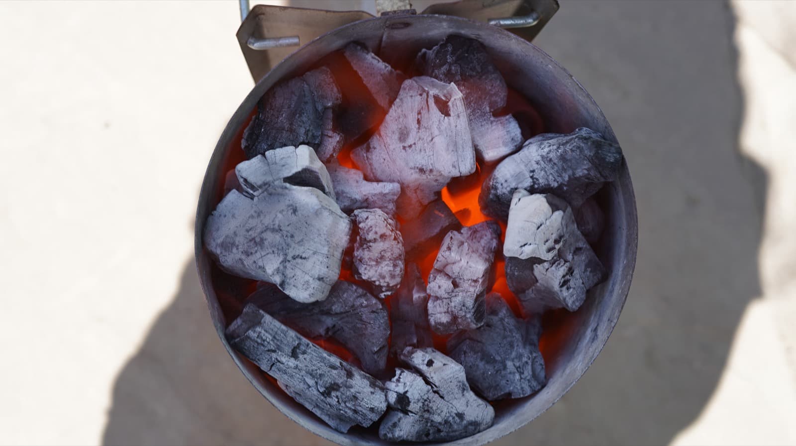 Lit binchotan charcoal in the chimney starter, overhead view