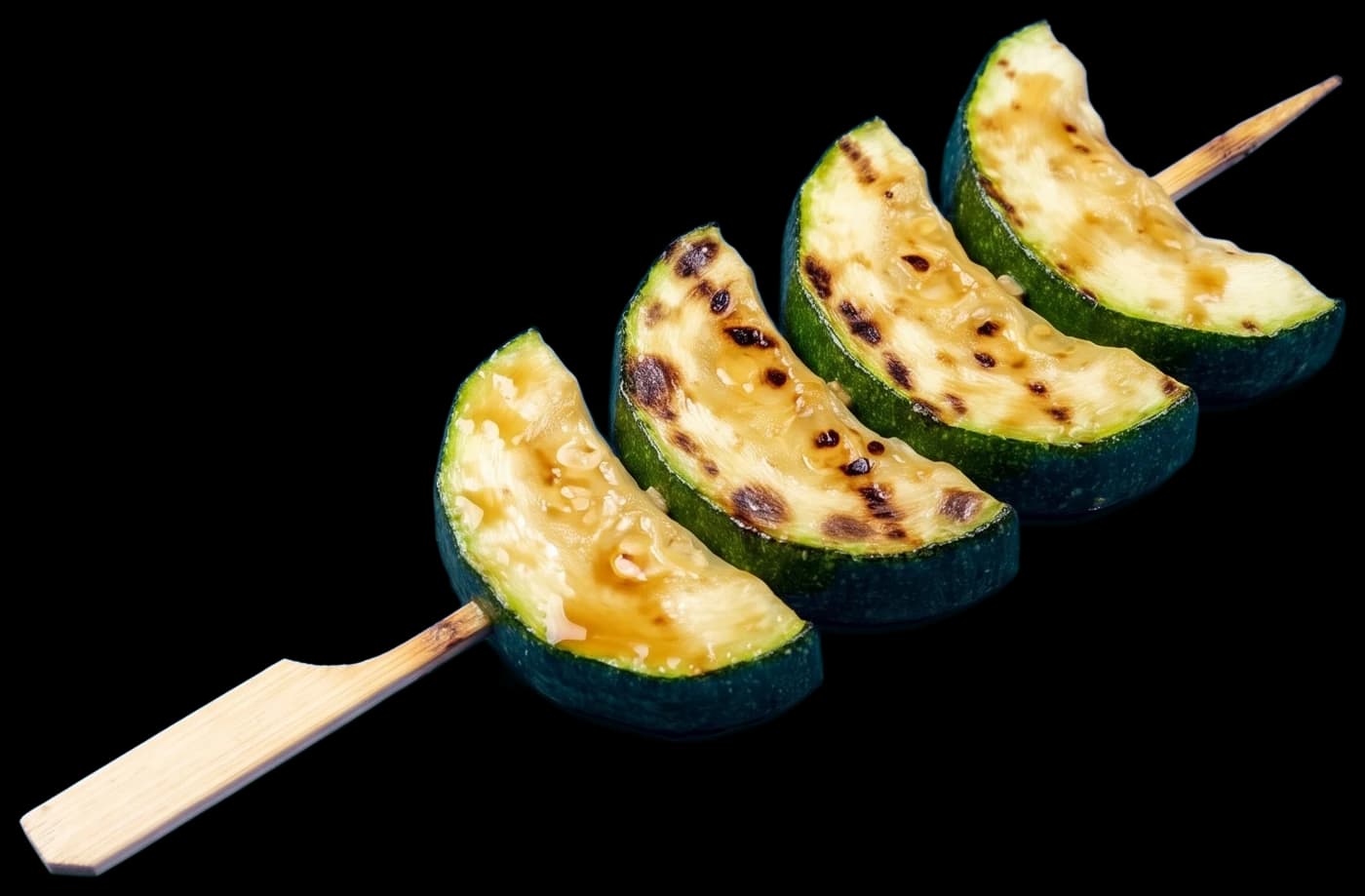 A zucchini skewer: thick half-moons of zucchini with grill marks, brushed with tare